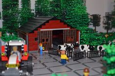 a lego farm scene with people and cows