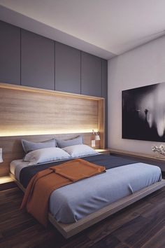 a large bed sitting in the middle of a bedroom next to a painting on the wall