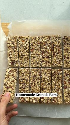 homemade granola bars cut into squares and placed on top of parchment paper with stickers