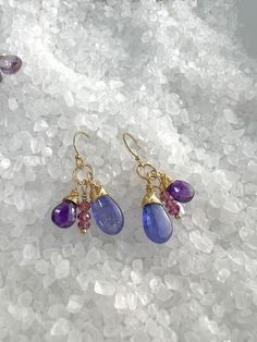 Smooth, shiny Tanzanite Briolettes, faceted dark Amethyst & faceted Rhodolite Garnets are hand wrapped and dangle from gold filled ear wires. These colors accent each other beautifully and are full of movement. Very fun, pretty earrings. Earrings measure 1 1/4" from top of the ear wires. Width approx.: 5/8". All components are gold filled. Silicon ear wires included. Faceted Amethyst Dangle Earrings, Purple Briolette Wire Wrapped Earrings, Purple Briolette Earrings With Natural Stones, Dark Amethyst, Rhodolite Garnet, Hand Wrap, Pretty Earrings, Accent Colors, Ear Wires