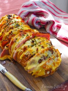 ham and cheese stuffed potatoes on a cutting board