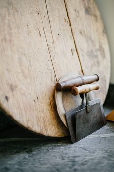 an old wooden board with tools attached to it