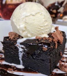 a piece of chocolate cake with ice cream on top