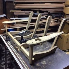 several wooden chairs sitting on top of a table in a room filled with boxes and other items