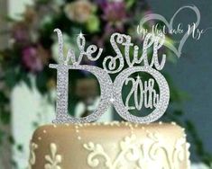 a wedding cake with the words we still do on it and sparkles in the air