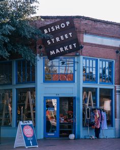 a blue building with a sign in front of it that says shop street market on the outside