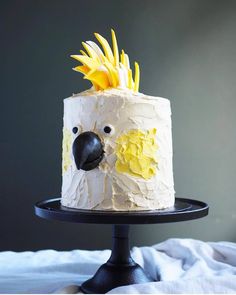 a cake with white frosting and yellow flowers on top