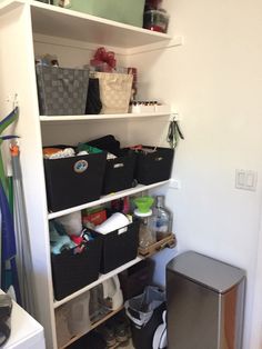 the closet is filled with many items and storage bins, including baskets, bookshelves, and other things