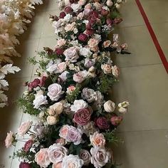 a long row of flowers on the floor