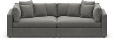 a gray couch with lots of pillows on the armrests and back rest area