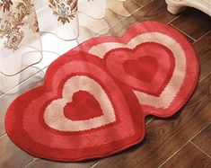 two heart shaped rugs sitting on the floor