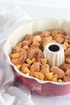 a bundt cake in a red pan with sugar on the top and brown toppings