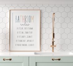 a bathroom with a sink, mirror and framed print on the wall next to it's faucet