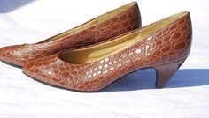 This is a pair of mock croc 1970s vintage shoes from the Contessa brand of the British shoe store Freeman Hardy Willis.  They have a pointed front and shiny tan colored mock croc exterior. They have a low heel and it is shaped attractively so that it curves slightly inwards. Very unusual! Browse and buy here: https://www.etsy.com/uk/listing/229067575/vintage-1970s-contessa-mock-croc-womens?ref=related-0 Retro Closed Toe Heels In Vintage Brown, Retro Vintage Brown Closed Toe Heels, Retro Brown Synthetic Heels, Traditional Brown Slip-on Clogs, Vintage Brown Retro Closed-toe Heels, Tan Color, Court Shoes