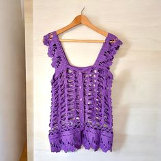 Elevate your boho-chic style with our Crochet Purple Vest for women - a versatile and charming addition to your wardrobe. This handmade boho top is not just a garment; it's a work of art that seamlessly blends comfort with fashion. Whether you're searching for a thoughtful gift or looking to enhance your own wardrobe, this Crochet Versatile Boho Top with buttons is the perfect choice. Boho Elegance in Purple: Embrace the free-spirited charm of bohemian fashion with our Crochet Purple Vest. The rich purple hue adds a touch of sophistication, making it a standout piece in your collection. Handmade with Precision: Each vest is meticulously crocheted by skilled artisans, ensuring a high level of craftsmanship and attention to detail. The result is a unique and beautifully crafted boho top that Bohemian Macrame Crochet Top, Bohemian Hand Knitted Crochet Top For Vacation, Hand Knitted Bohemian Crochet Top, Handmade Bohemian Crochet Top For The Beach, Hand Knitted Cotton Crochet Top In Bohemian Style, Handmade Bohemian Cotton Crochet Top, Bohemian Purple Crochet Top For Summer, Purple Bohemian Crochet Top For Summer, Purple Bohemian Crochet Top For Festival