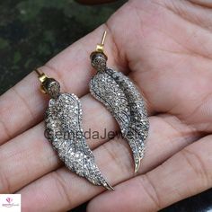 Pave Diamond Earrings, 14k Gold Earrings Jewelry, 925 Silver Earrings, Diamond Feather Earrings, Diamond Angel Wings Earrings, Gift For her Earring Details: Item Code: GJ-ER0029 Gold Weight: 0.35 gm Diamond Weight: 1.85 Cts Gross Weight: 7.93 Grams Earring Size: 43X13 MM 14 k Yellow Gold Earrings NOTE:- All The Products Are Designed And Manufactured In My Workshop By Me & My Team. Shown Products Are Purely Handmade. Custom Orders Are Open Handly Accepted. We Are the Perfect Choice For Any Cu Handmade Silver Wing-shaped Earrings, White Gold Sterling Silver Earrings With Rose Cut Diamonds, Luxury Hallmarked Pendant Earrings, Sterling Silver Earrings With Rose Cut Diamonds, Hand Set Pendant Earrings In Fine Jewelry Style, Angel Wings Earrings, Diamond Angel, Wings Earrings, Pave Diamond Jewelry