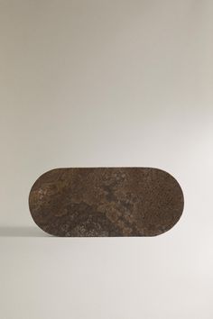 a skateboard is sitting on top of a white surface and it appears to be rusted