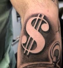 a man's arm with a dollar sign tattoo on it