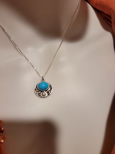 "Lovely, delicate oval pendant set in 925 sterling silver.  Setting has  a tiny butterfly design.  Pendant is set with what appears to be howlite and a pearl, but provenance is unknown and the  gems have not been tested; pendant is priced accordingly.  Pendant is 3/4 \" wide by 5/8 \" high, and chain is 16\" long.  Chain is silver, but not sterling." Unique Turquoise Oval Pendant Jewelry, Southwestern Turquoise Oval Pendant Necklace, Spiritual Cabochon Oval Pendant Jewelry, Southwestern Blue Oval Pendant Jewelry, Chrysocolla Gemstone Oval Pendant Jewelry, Tiny Butterfly, Coral Beads Necklace, Coral Pendant, Southwestern Design