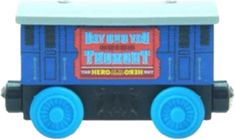 a small toy train with blue wheels and an advertisement on the side that says, bay town freight