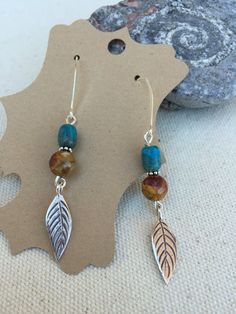 "🌵 Thank You for Visiting Desert Valley GEMS! 🌵 Sterling Silver leaves dangle from bright Turquoise with warm Jasper. The French Hooks are also Sterling Silver. Hallmarked 925. Earrings, Length - 1 3/4\" from top to bottom For Specials and Coupon Codes, Visit my Facebook page: https://www.facebook.com/Jewelry.by.Tina.Tretina" Desert Valley, Earrings 2024, Leather Cord Jewelry, Twisted Tree, Silver Leaves, Wrap Earrings, Cord Jewelry, Bright Turquoise, Beading Jewelry