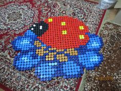 a very large piece of art made out of legos on a rug in the middle of a room