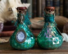 two green vases sitting on top of a wooden table