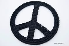 a peace sign made out of black crochet