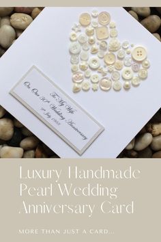 a wedding card with buttons on it and the words luxury handmade pearl wedding anniversary card more than just a card