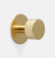 a gold door handle on a white wall