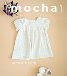 a white dress and baby shoes on a pink background with the words inochal above it