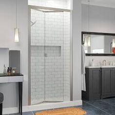 a bathroom with a walk in shower next to a sink