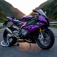 a purple motorcycle parked on the side of a road