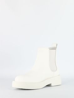 Step out in style with these exquisite white leather Chelsea boots. The matte finish adds a touch of sophistication, while the side elastic bands and back tie provide both comfort and a trendy look. With a 4cm height, these boots are perfect for any occasion, whether it's a casual day out or a special evening event. Made in the UK, these Chelsea boots are a symbol of quality craftsmanship and timeless elegance. White Chelsea Boots, White Leather Boots, Clarks Women's, Prada Designer, Leather Chelsea Boots, Designer Sunglasses, Watch Design, White Leather, Elastic Band