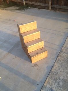 three wooden steps sitting on top of cement