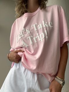 Introducing our newest addition to the travel inspired collection - the Let's Take a Trip Pink Tee! Made with a lightweight cotton blend for ultimate comfort, this tee features a stunning 3D white puff print graphic detailing that will make you stand out on your next adventure. Get ready to turn heads and inspire your next trip in style! Pink T-shirt For Summer Loungewear, Oversized Pink Slogan Top, Pink Slogan T-shirt For Loungewear, Pink Text Print Vacation Tops, Pink Graphic Print T-shirt For Loungewear, Pink Text Print T-shirt For Loungewear, Pink T-shirt With Text Print For Loungewear, Pink Text Print T-shirt, White Cotton Top For Travel