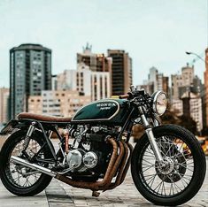 a motorcycle parked in front of a cityscape