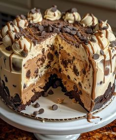 a cake with chocolate chip cookies and cream frosting on top is cut in half