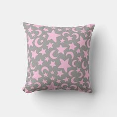 a gray and pink pillow with stars and crescents on it