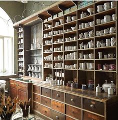 an old wooden cabinet filled with lots of pots and pans