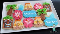 decorated cookies on a white plate with the word moan written in large letters and flowers