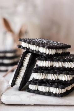 cookies with white and black icing stacked on top of each other