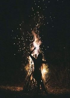 a person standing in front of a fire