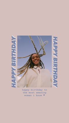 a woman with braids on her head is smiling and wearing a white shirt that says happy