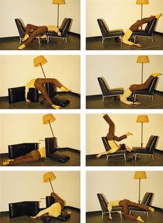 a man laying on the floor next to a chair with a lamp in his hand