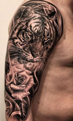 a man with a tiger and roses tattoo on his arm