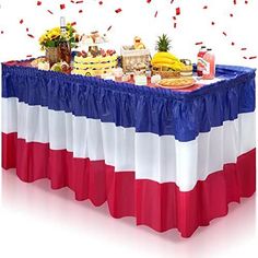 a table covered in food and confetti with red, white, and blue colors