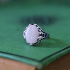 14 x 10mm cabochon on an antiqued sterling silver plated or brass adjustable ring.  Easy to adjust to any size. Choose from Rose Quartz, Amethyst or Rhodonite. Vintage Adjustable Oval Moonstone Ring, Vintage Oval Crystal Ring With Natural Stones, Vintage Oval Moonstone Ring With Natural Stones, Vintage Moonstone Ring With Large Stone For Gift, Vintage Moonstone Ring With Large Stone As Gift, Rhodonite Ring, Tiara Accessories, Black Onyx Stone, Amethyst Quartz