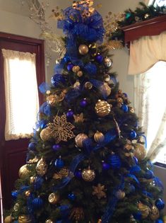 a christmas tree with blue and gold decorations