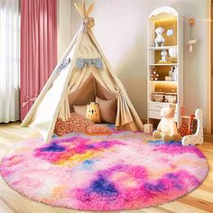 a child's bedroom with a teepee tent and pink rug